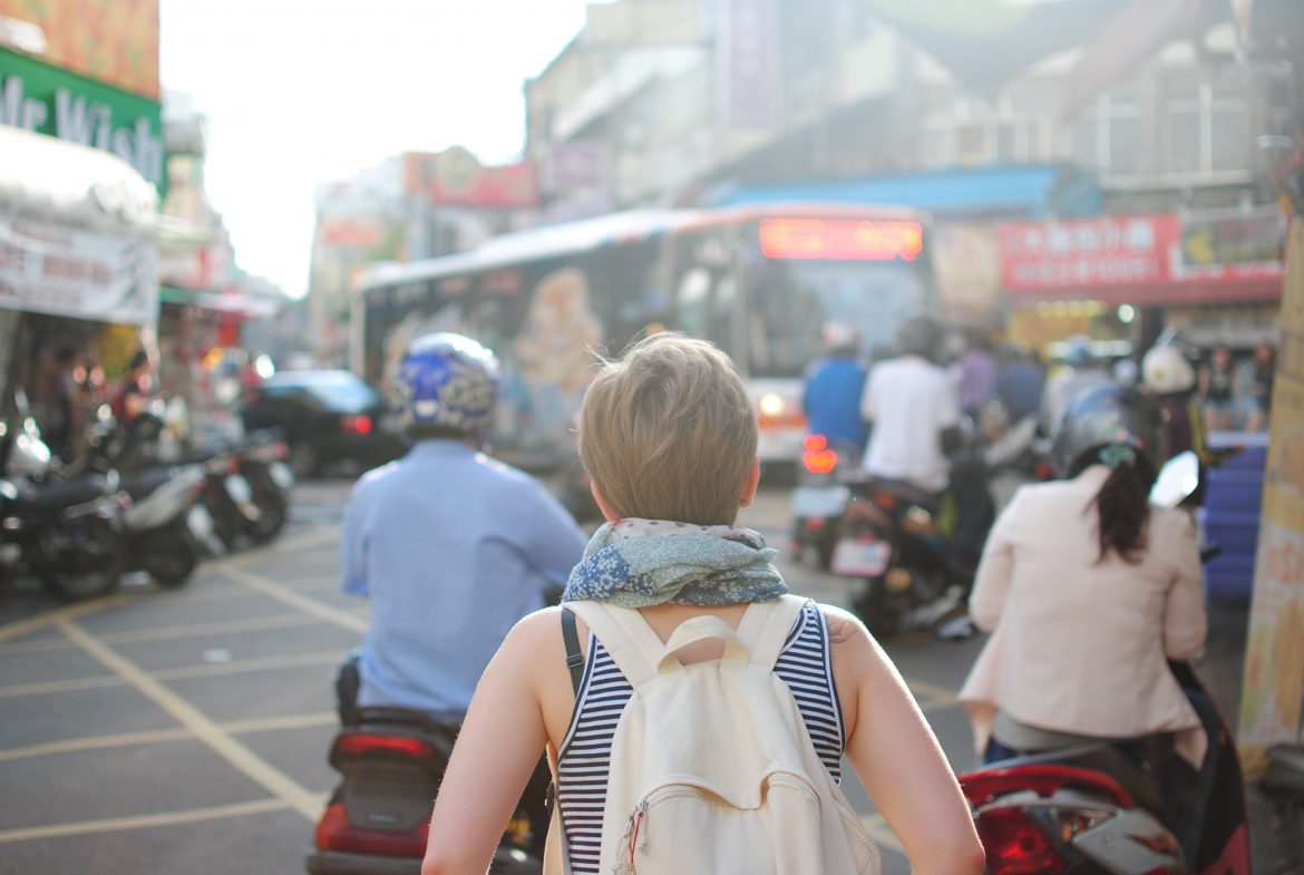 Woman walking through busy traffic in Paraguay