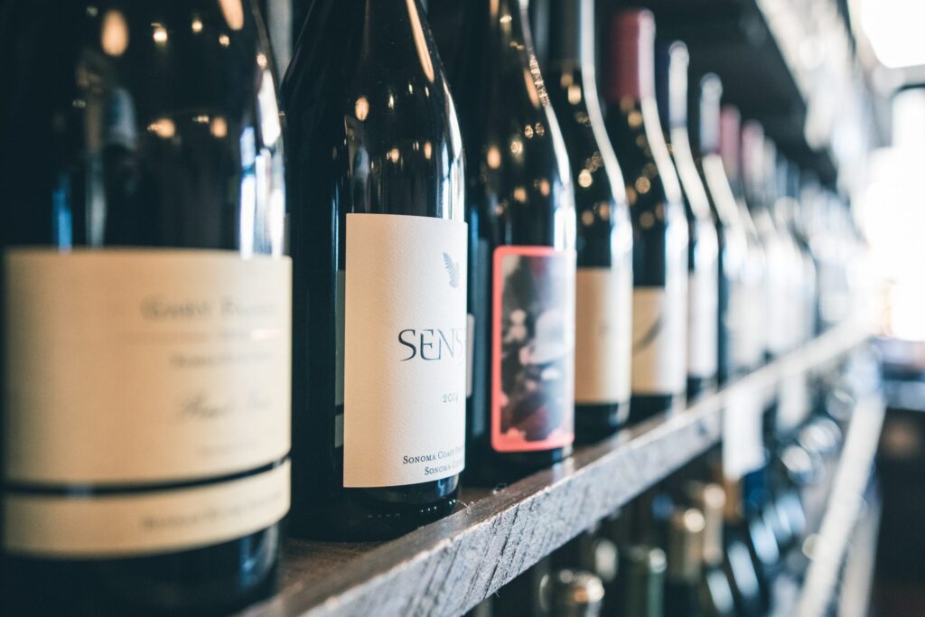 Wine bottles lined up on a shelf