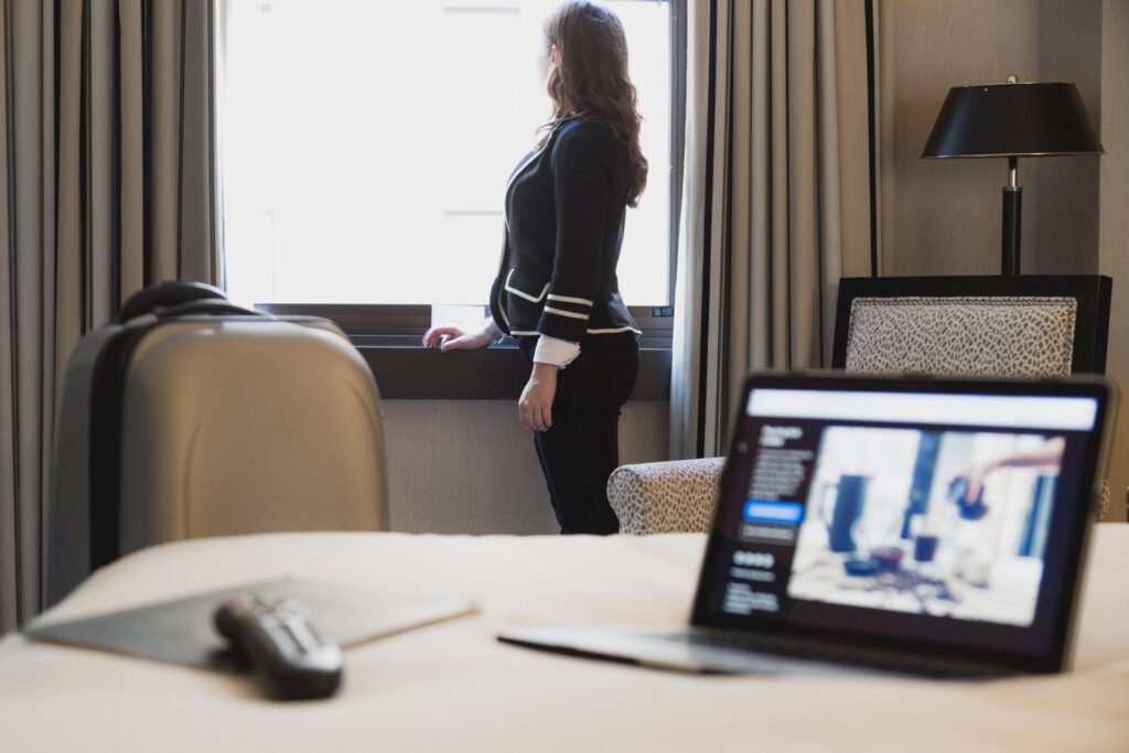 Woman looking out the window in hotel room