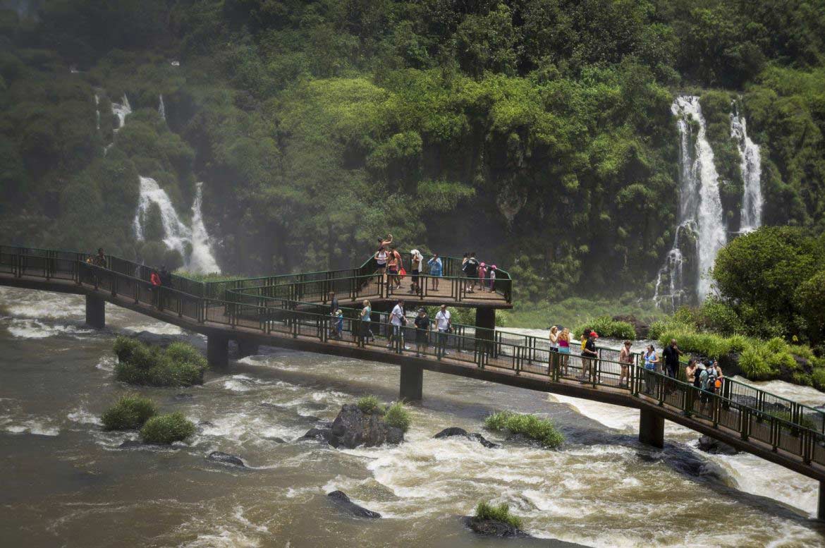 Tourists on the footbridge of the Iguazu Falls