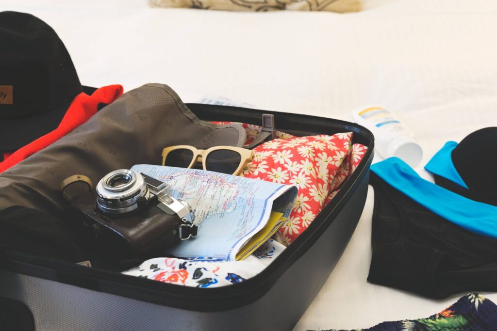 Open suitcase with vacation items