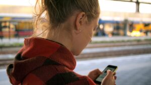 Woman using travel app on cellphone