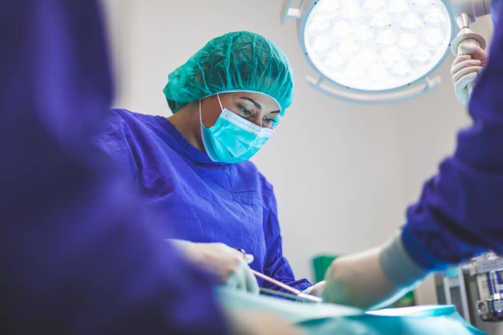 Female doctor operating in operating room